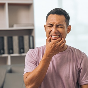 a man dealing with sudden dental pain