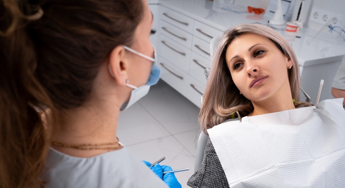 Woman visiting her emergency dentist in Arlington
