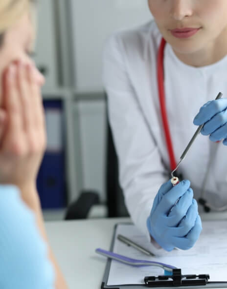 Dentist talking to a patient at a desk