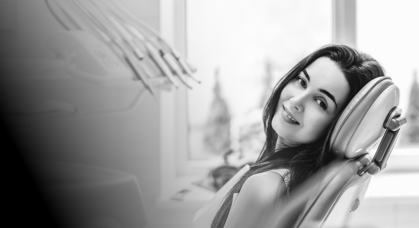 Smiling woman leaning back in dental chair