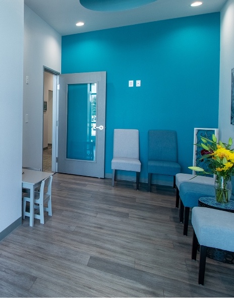 Dental office reception area with blue and white walls