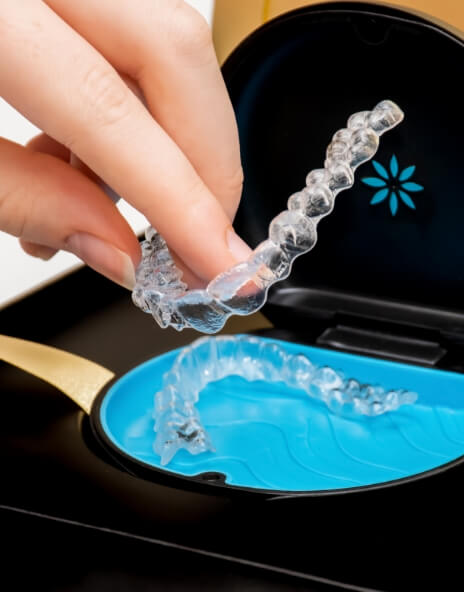 Person placing Invisalign aligner back in its case