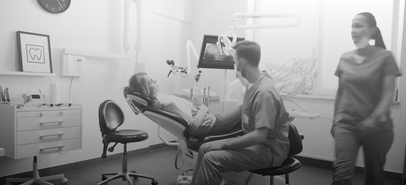 Dentist talking to a patient in dental chair