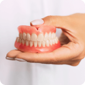 Dentist holding a set of full dentures