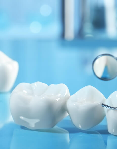Several dental crowns on table