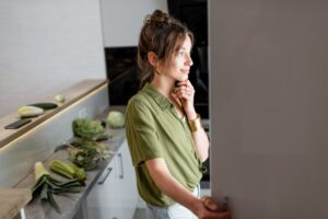 woman looking through her refrigerator